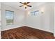 Well-lit bedroom with hardwood floors and ceiling fan at 1107 Sugar Loaf Key Loop, Lady Lake, FL 32159