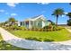 House exterior showcasing landscaping and a palm tree at 1107 Sugar Loaf Key Loop, Lady Lake, FL 32159