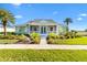 Charming green house with white accents and a welcoming porch at 1107 Sugar Loaf Key Loop, Lady Lake, FL 32159