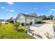 Exterior view of house, two-car garage, and landscaped yard at 1107 Sugar Loaf Key Loop, Lady Lake, FL 32159