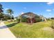 Home's exterior showcasing landscaping and pool enclosure at 1107 Sugar Loaf Key Loop, Lady Lake, FL 32159