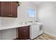 Laundry room with washer, dryer, and cabinets at 1107 Sugar Loaf Key Loop, Lady Lake, FL 32159