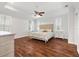 Large main bedroom with hardwood floors and a tufted headboard at 1107 Sugar Loaf Key Loop, Lady Lake, FL 32159