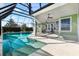 Inviting pool with screened-in patio and lounge chairs at 1107 Sugar Loaf Key Loop, Lady Lake, FL 32159