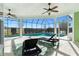 Relaxing screened pool area with lounge chairs and ceiling fans at 1107 Sugar Loaf Key Loop, Lady Lake, FL 32159