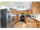 Galley kitchen with stainless steel appliances at 11146 Pine St, Leesburg, FL 34788