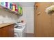 Laundry room with washer and pegboard wall at 11146 Pine St, Leesburg, FL 34788