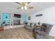 Living room with stone fireplace and comfy seating at 11146 Pine St, Leesburg, FL 34788