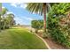 Spacious backyard with lush landscaping, overlooking a lake at 1149 Eureka Mill Run, The Villages, FL 32162