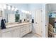 Spa-like bathroom with double vanity and granite countertop at 1149 Eureka Mill Run, The Villages, FL 32162