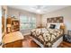 Cozy bedroom with wood floors and a queen-size bed at 1149 Eureka Mill Run, The Villages, FL 32162