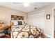 Well-lit bedroom featuring wood floors and ample closet space at 1149 Eureka Mill Run, The Villages, FL 32162