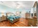 Main bedroom with hardwood floors, ceiling fan, and en-suite bathroom at 1149 Eureka Mill Run, The Villages, FL 32162