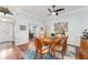 Bright dining room with hardwood floors, ceiling fan, and view to office at 1149 Eureka Mill Run, The Villages, FL 32162