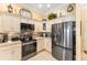 Kitchen with stainless steel appliances and granite countertops at 1149 Eureka Mill Run, The Villages, FL 32162