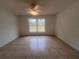 Bright bedroom with tile flooring and a large window at 11550 Foxglove Dr, Clermont, FL 34711