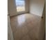 Bright bedroom with tile flooring and large window at 11550 Foxglove Dr, Clermont, FL 34711