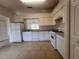 Kitchen featuring white appliances and ample cabinet space at 11550 Foxglove Dr, Clermont, FL 34711