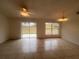 Living room with tile floors and access to the backyard patio at 11550 Foxglove Dr, Clermont, FL 34711