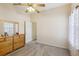 Bright bedroom with wood dresser and ceiling fan at 1209 Elysium Blvd, Mount Dora, FL 32757