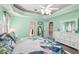 Bright bedroom with floral bedding, white dresser, and ceiling fan at 1209 Elysium Blvd, Mount Dora, FL 32757