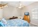 Bedroom with ceiling fan, TV, and wooden dresser at 1209 Elysium Blvd, Mount Dora, FL 32757