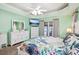 Main bedroom with large TV, white dresser, and access to backyard at 1209 Elysium Blvd, Mount Dora, FL 32757