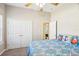 Bedroom with double doors, ceiling fan, and nautical decor at 1209 Elysium Blvd, Mount Dora, FL 32757