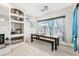 Bright dining area with wooden table and built-in shelves at 1209 Elysium Blvd, Mount Dora, FL 32757