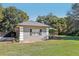 Gray house with a gray roof, white columns, and black shutters at 1209 Elysium Blvd, Mount Dora, FL 32757