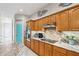 Kitchen with wood cabinets, granite countertops, and a pantry at 1209 Elysium Blvd, Mount Dora, FL 32757