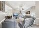 Bright living room with gray sofas, a fireplace, and high ceilings at 1209 Elysium Blvd, Mount Dora, FL 32757