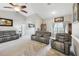 Living room with gray sofas and high ceilings, open to kitchen area at 1209 Elysium Blvd, Mount Dora, FL 32757