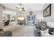 Spacious living room with gray reclining sofas and a large TV at 1209 Elysium Blvd, Mount Dora, FL 32757