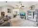 Spacious living room with gray sofas and a view of the pool at 1209 Elysium Blvd, Mount Dora, FL 32757