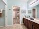 Double vanity bathroom with light teal walls at 12532 Hammock Pointe Cir, Clermont, FL 34711