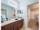 Double vanity bathroom with light teal walls at 12532 Hammock Pointe Cir, Clermont, FL 34711