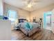 Bright bedroom with wood-look floors and a ceiling fan at 12532 Hammock Pointe Cir, Clermont, FL 34711