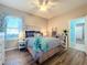 Bright bedroom with wood-look floors and a ceiling fan at 12532 Hammock Pointe Cir, Clermont, FL 34711