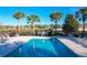 Refreshing community pool surrounded by palm trees at 12532 Hammock Pointe Cir, Clermont, FL 34711