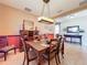 Formal dining room with a wood table, chandelier, and built-in hutch at 12532 Hammock Pointe Cir, Clermont, FL 34711