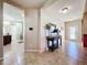 Spacious entryway with tile floors, offering views of the kitchen at 12532 Hammock Pointe Cir, Clermont, FL 34711