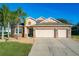 Two-story house features a three-car garage and landscaped yard at 12532 Hammock Pointe Cir, Clermont, FL 34711