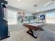 Game room with pool table and Seattle-themed wall art at 12532 Hammock Pointe Cir, Clermont, FL 34711