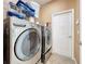 Laundry room with LG washer and dryer, and overhead shelving at 12532 Hammock Pointe Cir, Clermont, FL 34711