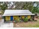 Small yellow house with a metal roof and small yard at 1319 Stowe Ave, Mount Dora, FL 32757