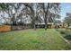 Spacious backyard with large trees and fence at 1319 Stowe Ave, Mount Dora, FL 32757