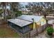 Back of house with screened porch and metal roof at 1319 Stowe Ave, Mount Dora, FL 32757