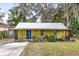 Front view of yellow house with screened porch at 1319 Stowe Ave, Mount Dora, FL 32757