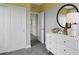 Youth bedroom with white dresser, closet, and yellow-gray walls at 13243 Peaceful Melody Dr, Winter Garden, FL 34787